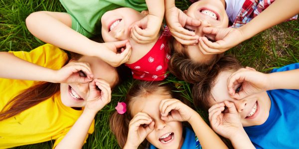 Group of cute children lying on grass